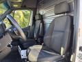 Interior of a 2024 Mercedes-Benz Sprinter 2500 featuring two black fabric seats and a steering wheel