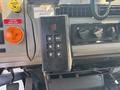 Black gear shift lever with buttons for parking reverse neutral drive and mode settings in a 1999 Freightliner FL80 truck cabin