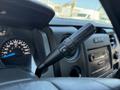 The image shows the dashboard control of a 2014 Ford F-150 featuring a gear shift lever with additional controls for drive settings