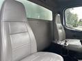 Interior view of a 2006 Freightliner M2 106 showing two gray leather seats and a control panel between them