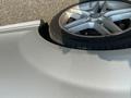 A silver 2013 Mercedes-Benz C-Class with a wheel resting on its roof