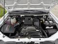 The image shows the engine compartment of a 2012 GMC Canyon with visible components including the engine block air intake battery and coolant reservoir