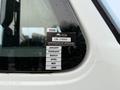 A certification sticker on a window displaying approval details and the months January to June for a vehicle identified as GM 19960