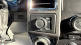 Close-up of a control switch panel in a 2016 Ford F-150 featuring various knobs and buttons for vehicle settings