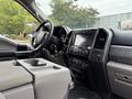 Interior of a 2020 Ford F-550 showing the dashboard center console and steering wheel with controls and displays visible