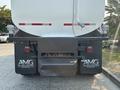 Rear view of a 2016 Freightliner M2 106 featuring a dark bumper and company logos with an exhaust pipe on the side