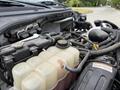 Close-up view of the engine compartment of a 2019 Ford F-750 showing the coolant reservoir and various engine components including hoses and connectors