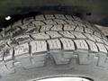 Close-up of a heavily treaded tire on a 2008 Ford Econoline showcasing deep grooves designed for traction and durability