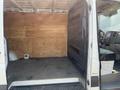 White 2016 Mercedes-Benz Sprinter van with an empty cargo space featuring wooden walls and a gray floor