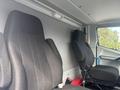 Two black upholstered seats in the cab of a 2020 Lion Lion6 vehicle with a minimalist design and no visible controls or dashboard features