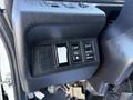 A close-up of the control panel in a 2015 Hino 358 featuring switches for off mode select and other functions
