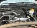 The engine compartment of a 2015 RAM 1500 showing various components including the air intake, cooling system, and various hoses and wires