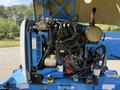 A 2012 Genie Z 45/25 with an exposed engine compartment displaying various mechanical components and hoses in multiple colors