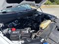 A 2021 Ford F-150 engine bay showing the engine components battery and fluid reservoirs