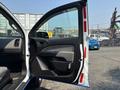 A 2017 Chevrolet Colorado with the driver's side door open, showcasing the interior door panel and handle.