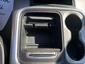 Interior view of the center console of a 2018 RAM 3500 showing storage compartments and cup holders