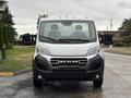 A 2023 RAM Promaster 3500 van facing forward with a silver front exterior and RAM branding on the grille