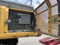 A 2018 John Deere 350 excavator with an open door revealing its interior components including the radiator and other machinery parts