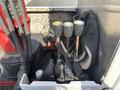 Close-up of the hydraulic control levers on a 2006 International 4300 showing three levers with different colored tops and connected hoses
