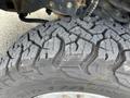 Close-up of a heavily treaded tire from a 2017 Ford F-250 SD showcasing deep grooves and rugged design for off-road capability