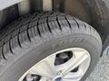 Close-up of a tire from a 2015 Ford Escape featuring a Toyo tire brand with visible tread patterns and a silver alloy wheel
