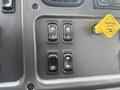 Control panel of a 2016 Freightliner 108SD featuring four switches and a yellow parking brake lever
