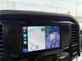 Interior dashboard of a 2021 Ford F-150 featuring a touchscreen display with navigation and music apps visible