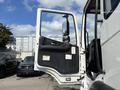 A 2012 Autocar Xpert truck with its driver side door open showcasing the interior and door panel details