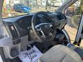 Interior view of a 2017 Ford Transit-350 showing the steering wheel dashboard and gear shift with a thank you mat on the floor