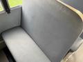 Close-up of a gray vinyl bench seat in a vehicle with a smooth surface and rounded edges