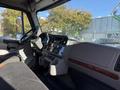 Interior view of a 2012 Freightliner M2 106 truck highlighting the dashboard steering wheel and control panel