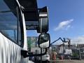 A 2019 Freightliner M2 106 truck showcasing its side mirrors and part of the cabin in the foreground