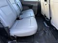 The image shows the rear seats of a 2020 Ford F-550 with gray upholstery and a rubber floor mat