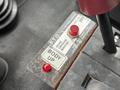 Close-up of a control panel featuring a red button labeled "BODY UP" and a switch for P.T.O with instructions for operation
