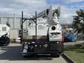 A 2008 Kenworth T370 equipped with a utility bucket lift in the rear and an extended boom for maintenance or construction work