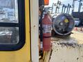 A yellow 1993 Hyster H80XL forklift with a mounted fire extinguisher attached to its side and a gas cylinder nearby