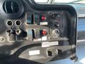 Interior dashboard of a 2012 Ford Econoline featuring various switches knobs and indicators