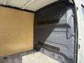 Interior view of a 2021 Mercedes-Benz Sprinter van showing a spacious cargo area with a wooden panel and grey wall lining