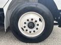 Close-up of a wheel from a 2006 Freightliner M2 106 showing the white rim and black tire with visible lug nuts and tread details