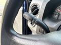 Close-up of a steering wheel control stalk in a 2013 Ford E-350 Super Duty featuring functions for headlights and windshield wipers
