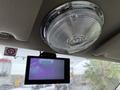 A 2008 Ford F-450 SD is displayed on a digital monitor mounted on the vehicle's interior with a round light fixture above it