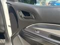 Interior door panel of a 2017 Chevrolet Colorado featuring control buttons for windows and locks with a textured surface and sleek design