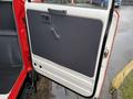 The image shows the interior door of a 2001 Toyota Dyna featuring a manual window crank and a simple design with a gray panel and door handle