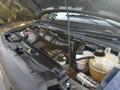 Engine compartment of a 2013 Ford E-350 Super Duty showing the engine bay with various components and fluids visible