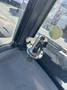 A chrome hazard light switch mounted on the dashboard of a 2010 New Holland T4050 tractor