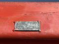 A metal plate on a piece of equipment with the numbers 617 8101 engraved on it