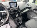 Interior view of a 2019 Ford Transit Connect dashboard with a touchscreen display gear shift and various controls