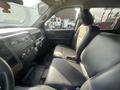 Interior of a 2012 RAM 2500 showing the front seats and dashboard with controls and seating surfaces in black leather