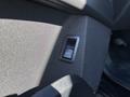 Close-up of a button in the 2023 Fisker Ocean interior used for unlocking or opening the car door