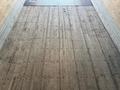 The image shows the interior of a trailer with a flat wooden floor featuring grooves and holes for securing cargo